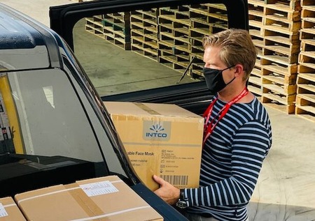 volunteer loading supplies into a truck for volunteer management and retention